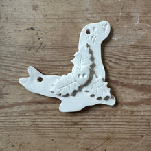 Load image into Gallery viewer, Small seal decoration with holly on a wooden background