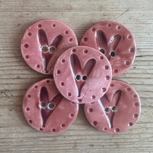 Load image into Gallery viewer, Pink ceramic buttons with decorative spots on a wooden surface