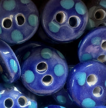 Load image into Gallery viewer, Blue ceramic buttons with turquoise polka dots on a dark background