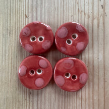 Load image into Gallery viewer, Four dark pink buttons with pink spots on a wooden surface