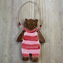 Load image into Gallery viewer, Decorative bear in a pink and white striped swimsuit on a textured surface