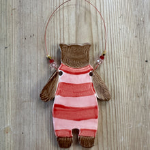 Load image into Gallery viewer, Decorative bear in a striped swim suit on a textured surface