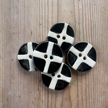Load image into Gallery viewer, Black and white ceramic buttons on a wooden surface