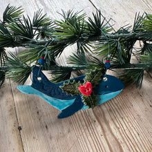 Load image into Gallery viewer, Decorative whale with holly on a wooden surface