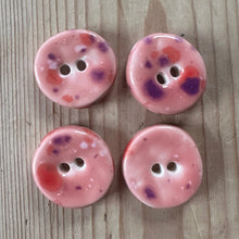 Load image into Gallery viewer, Four pink buttons with speckles on a wooden surface