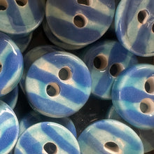 Load image into Gallery viewer, Collection of blue and turquoise striped ceramic buttons.