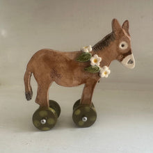 Load image into Gallery viewer, Ornamental donkey with wheels on a plain background