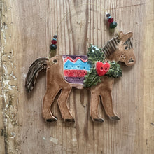 Load image into Gallery viewer, Decorative horse figure with colourful saddle on a wooden surface