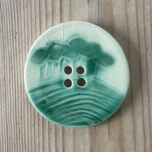 Load image into Gallery viewer, Green ceramic button on a wooden surface