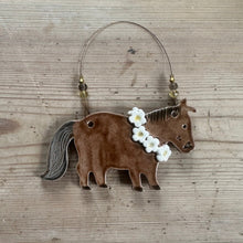 Load image into Gallery viewer, Decorative horse ornament with flowers on a wooden surface