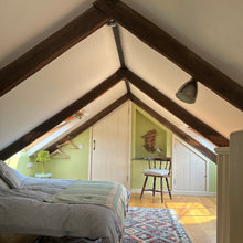 Load image into Gallery viewer, Mezzanine bedroom with wooden beams, bed, and rug.