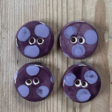 Load image into Gallery viewer, Four purple buttons with lilac polka dots on a wooden surface