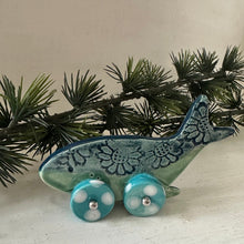 Load image into Gallery viewer, Ceramic whale ornament with blue patterns on wheels against a white background