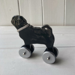 Black Pug "Woof on Wheels" ceramic ornament