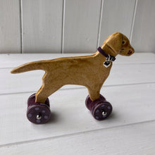 Load image into Gallery viewer, Yellow Labrador Ceramic "Woof on Wheels" Ornament