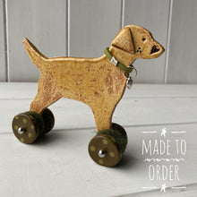 Load image into Gallery viewer, Yellow Labrador Ceramic "Woof on Wheels" Ornament