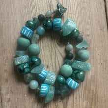 Load image into Gallery viewer, Green beaded necklace on a wooden surface

