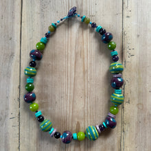 Load image into Gallery viewer, Colourful beaded necklace on a wooden surface

