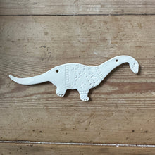 Load image into Gallery viewer, Unglazed dinosaur decoration on a wooden surface
