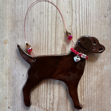 Load image into Gallery viewer, Brown dog-shaped decoration with a red collar on a textured surface
