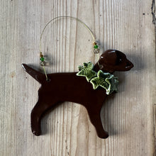 Load image into Gallery viewer, Decorative dog decoration with holly around its neck on a wooden surface
