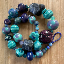 Load image into Gallery viewer, Colourful beaded necklace on a wooden surface
