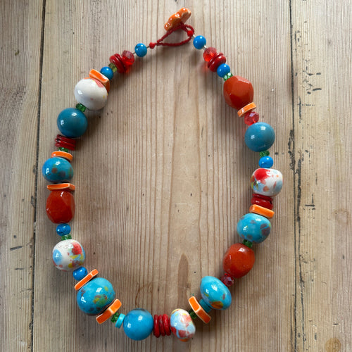 Colourful bead necklace on a wooden surface