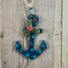 Load image into Gallery viewer, Decorative anchor with holly on a wooden surface

