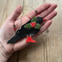 Load image into Gallery viewer, ceramic chough ornament with holly on a hand
