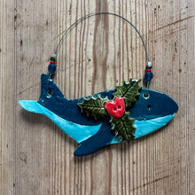Load image into Gallery viewer, Decorative whale ornament with holly leaves and a red berry on a wooden surface
