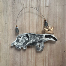 Load image into Gallery viewer, Decorative hanging badger ornament on a wooden surface

