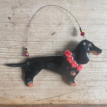 Load image into Gallery viewer, Decorative black dog ornament with red heart decorations on a wooden surface
