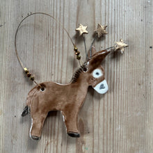 Load image into Gallery viewer, Decorative donkey ornament with stars on a wooden surface
