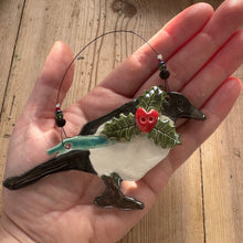 Load image into Gallery viewer, Hand holding a decorative bird ornament with a floral design on a wooden surface
