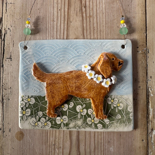 Decorative wall hanging with a brown dog illustration on a textured background