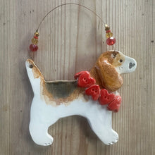 Load image into Gallery viewer, Decorative ceramic dog ornament with a red heart collar on a wooden surface
