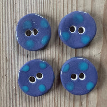 Load image into Gallery viewer, Four blue buttons with turquoise polka dots on a wooden surface

