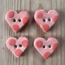Load image into Gallery viewer, Four pink heart-shaped buttons with polka dots on a wooden surface
