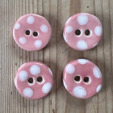 Load image into Gallery viewer, Four pink buttons with white polka dots on a wooden surface

