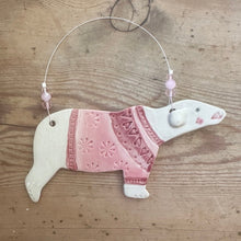 Load image into Gallery viewer, Decorative polar bear ornament with a pink sweater on a wooden surface
