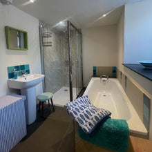 Load image into Gallery viewer, Modern downstairs bathroom with bathtub, sink, and shower area and toilet
