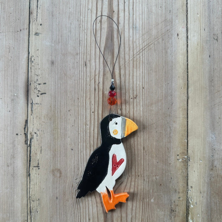 Decorative puffin ornament on a wooden surface