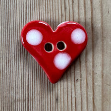Load image into Gallery viewer, Red heart-shaped ceramic button with white polka dots on a wooden surface
