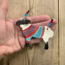 Load image into Gallery viewer, Decorative sheep ornament held in a hand on a wooden surface
