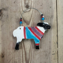 Load image into Gallery viewer, Decorative sheep ornament with a colorful sweater on a wooden surface
