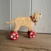 Load image into Gallery viewer, ceramic dog toy with red spotty wheels on a wooden surface
