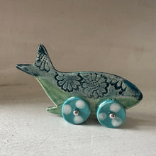Load image into Gallery viewer, Decorative whale figurine with wheels on a plain background
