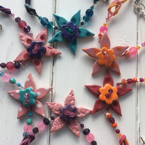 Flower necklaces on suede
