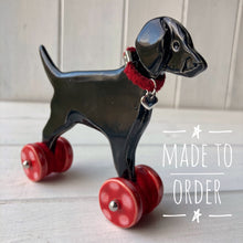 Load image into Gallery viewer, Black Labrador Ceramic &quot;Woof on Wheels&quot; Ornament
