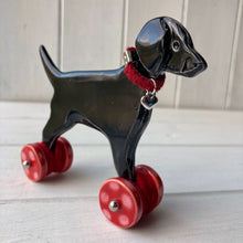 Load image into Gallery viewer, Black Labrador Ceramic &quot;Woof on Wheels&quot; Ornament
